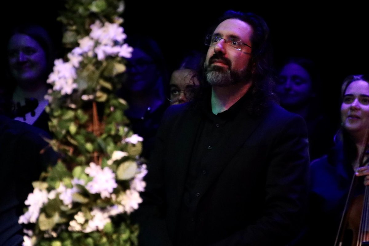 Cipriano stands at the end of the event to express gratitude to the audience. The Washburn Orchestra and Chorus performed music in the opera.